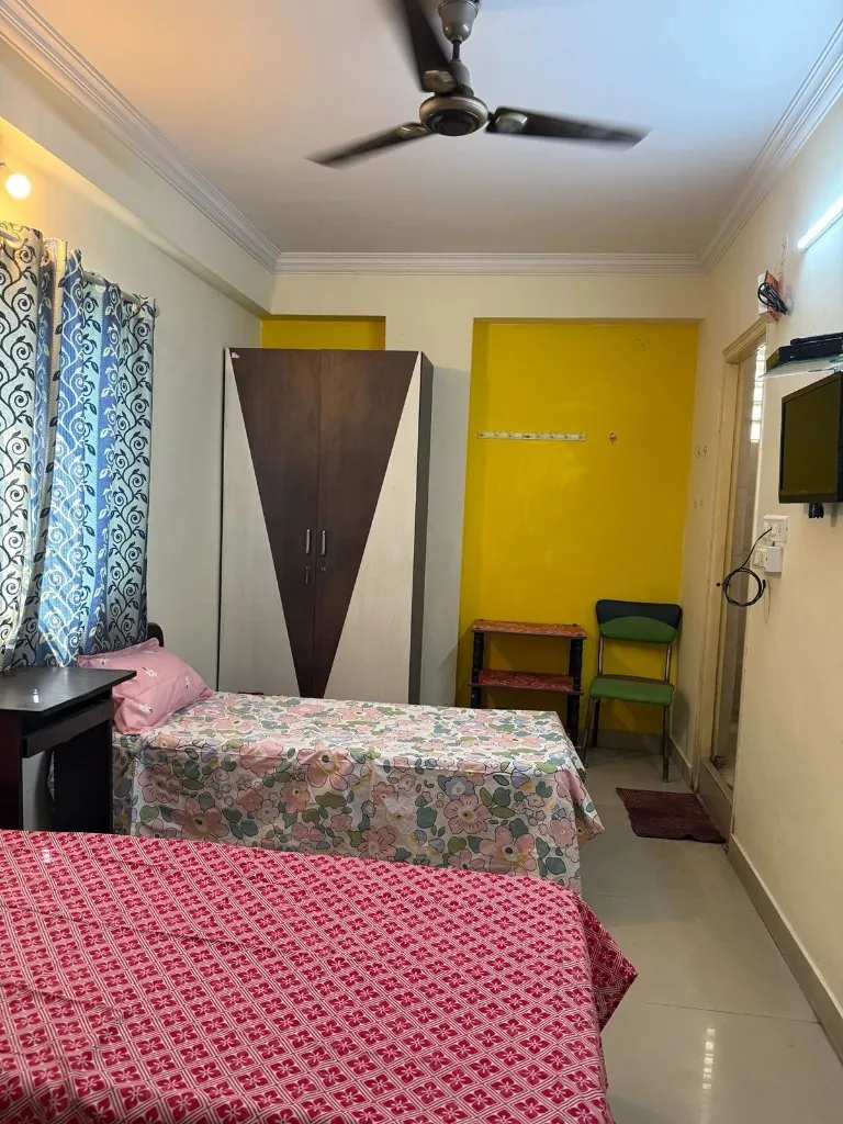 Furnished twin-share room at Gayatri Luxury Ladies PG