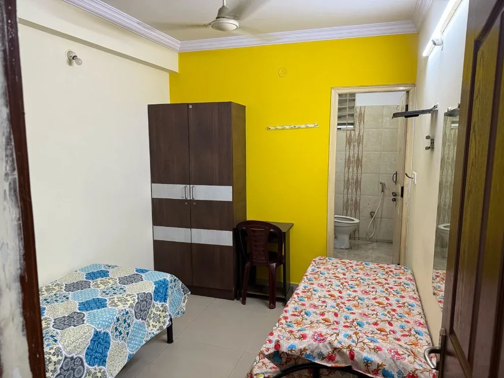 Twin-share room with attached bathroom at Gayatri Luxury Ladies PG