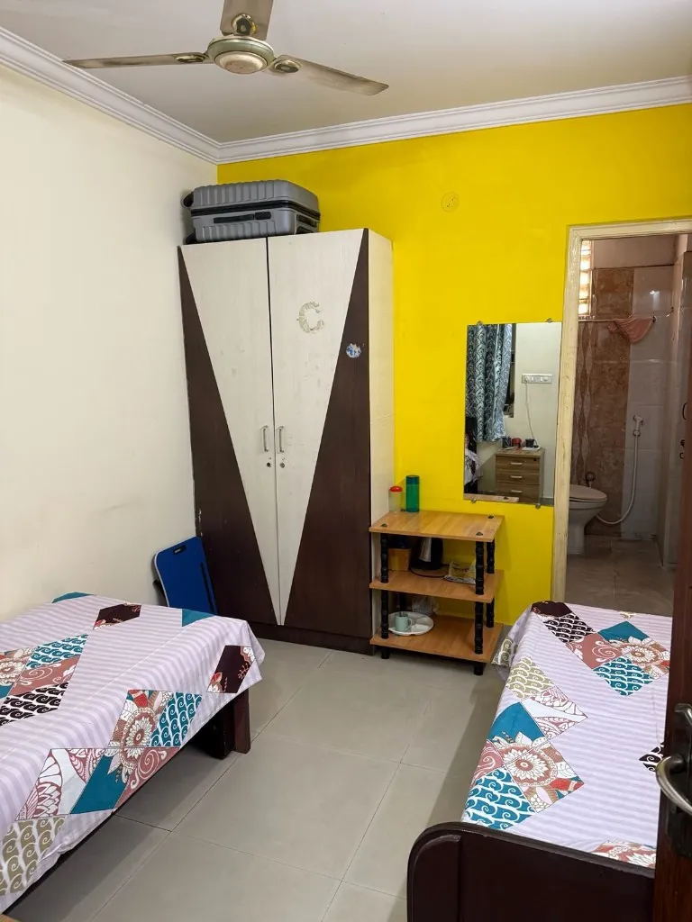 Twin-share room with wardrobe and attached bathroom at Gayatri Luxury Ladies PG