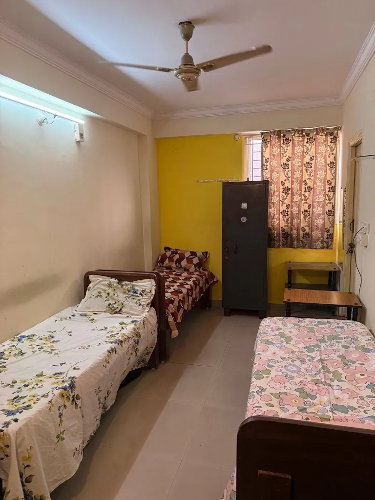 Triple-share room interior at Gayatri Luxury Ladies PG
